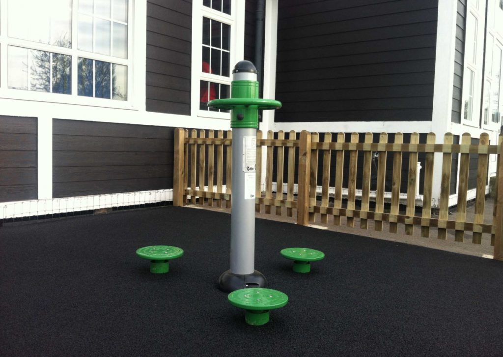 Body Twist outdoor gym equipment installed on wetpour safety surfacing.