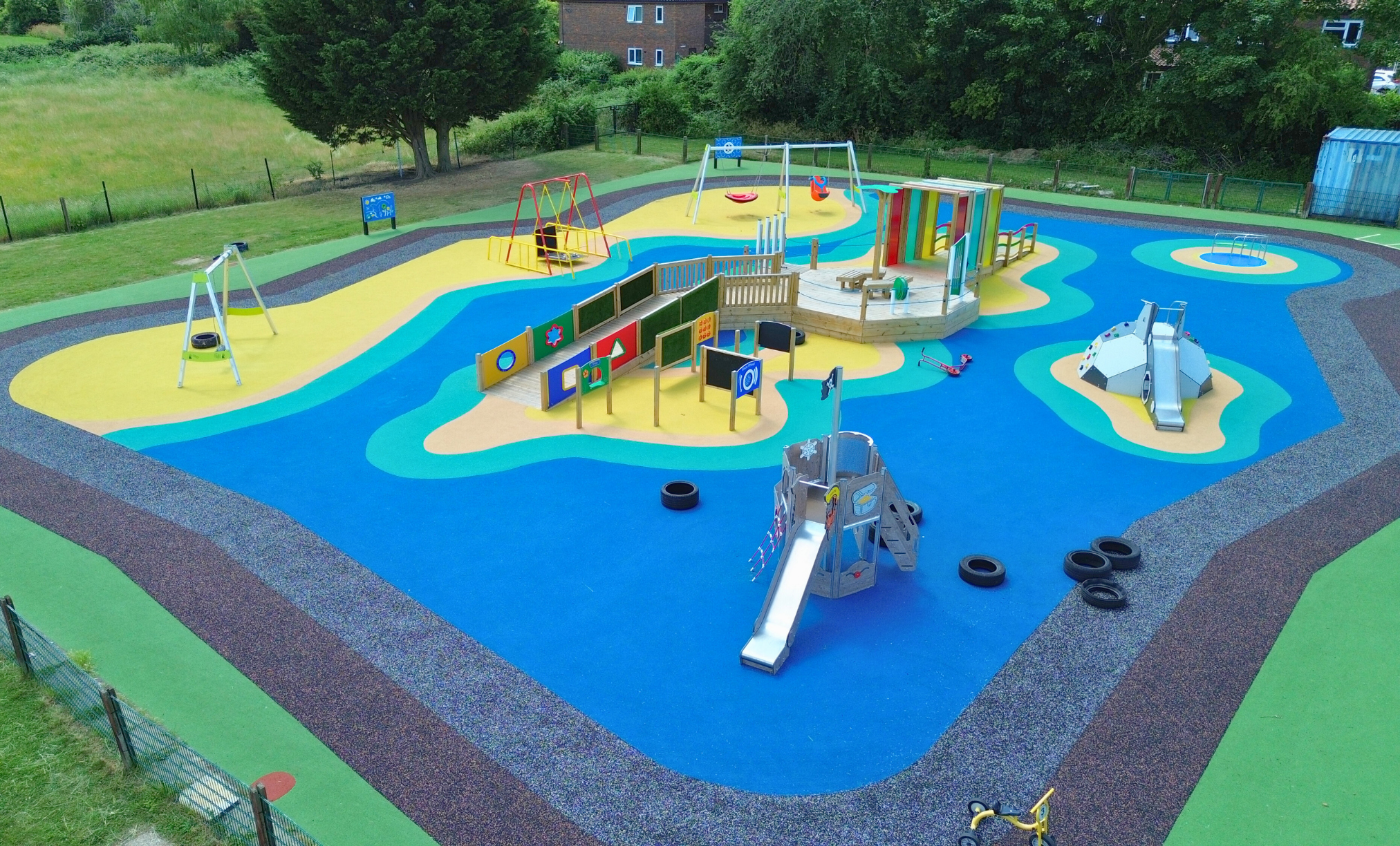 Inclusive playground project with wetpour safety surfacing and accessible equipment supporting community use